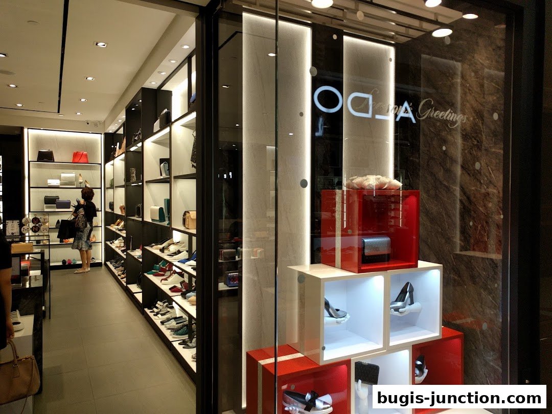 Interior view of a PEDRO shoe and handbag store with a customer browsing shelves.