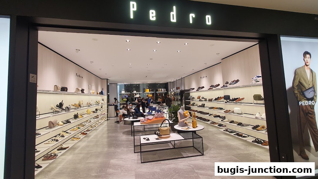 Interior view of a Pedro shoe and bag store, showcasing shelves filled with footwear and handbags.