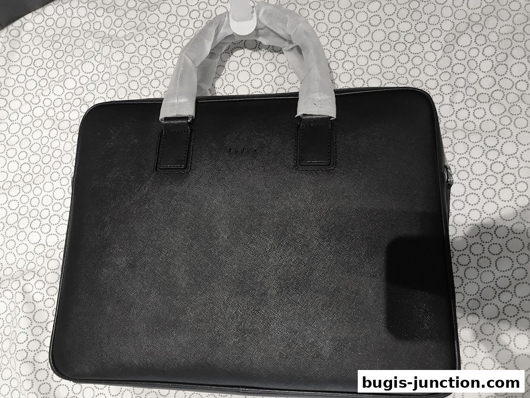 A black leather laptop bag with the PEDRO logo, wrapped in plastic.