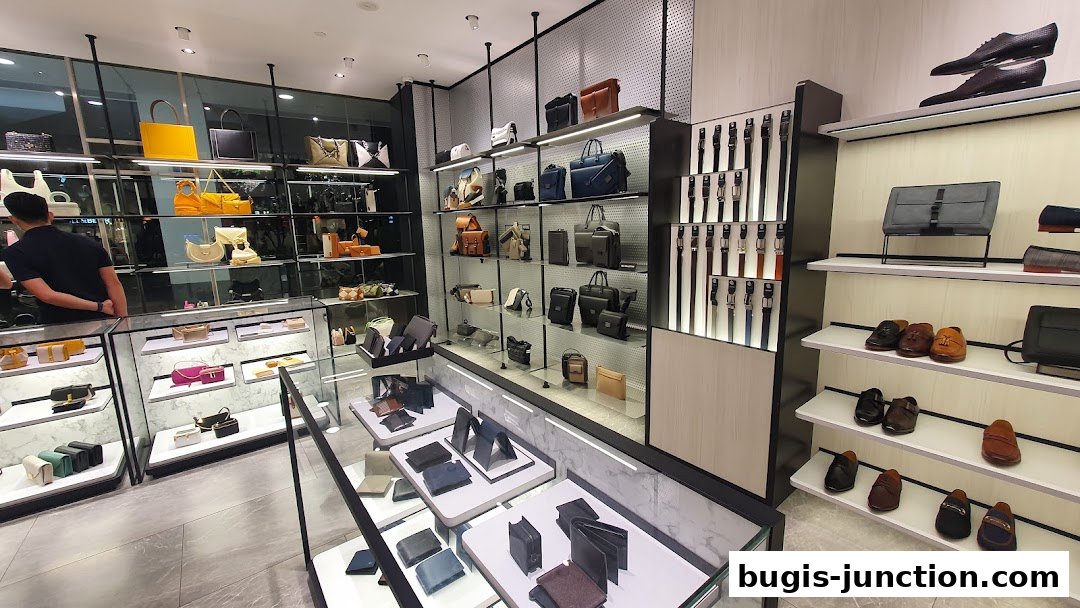 Interior view of a PEDRO store showcasing a wide selection of handbags, wallets, belts, and shoes.