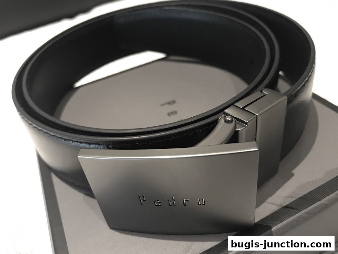 A close-up shot of a black leather belt with a modern silver buckle from PEDRO.