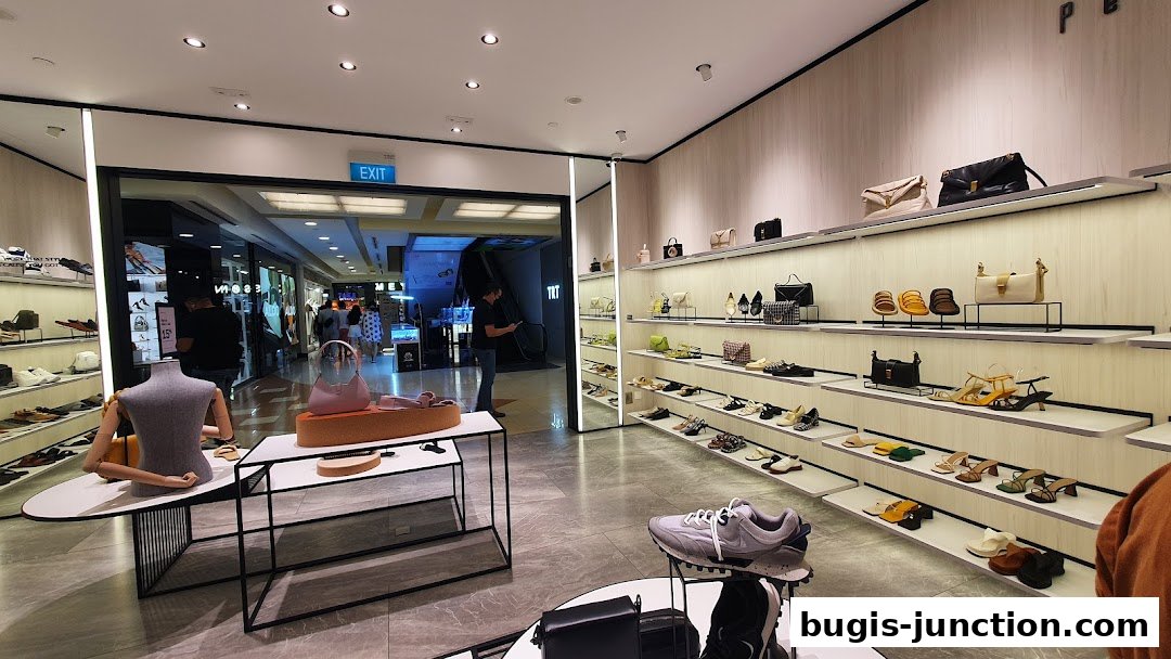 Interior view of a PEDRO shoe and handbag store showcasing various footwear and bags on display shelves.