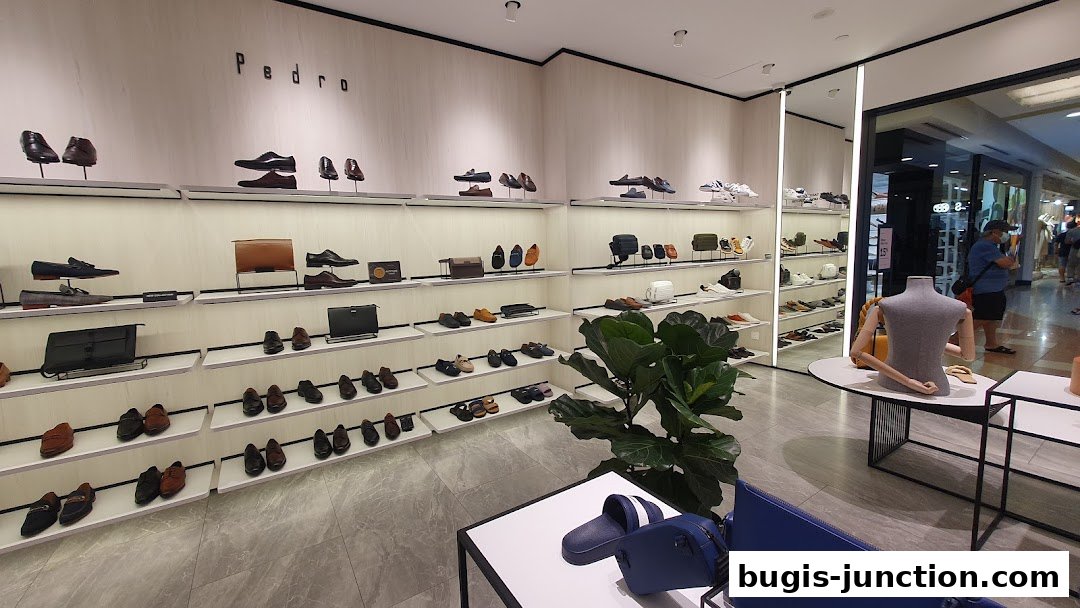Interior view of a Pedro shoe store showcasing a wide selection of men's footwear and accessories.