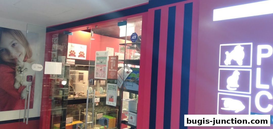 The entrance of Pet Lovers Centre, featuring a large image of a girl with a kitten and store signage.