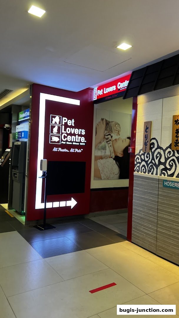 The entrance to Pet Lovers Centre, a pet store, with its logo and a large image of a woman and a cat.