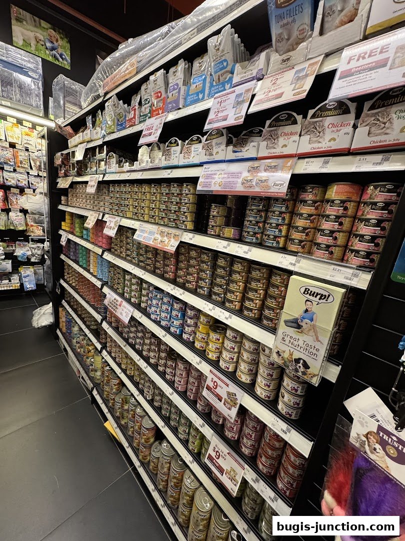 Shelves stocked with various pet food cans and pouches, featuring promotions.
