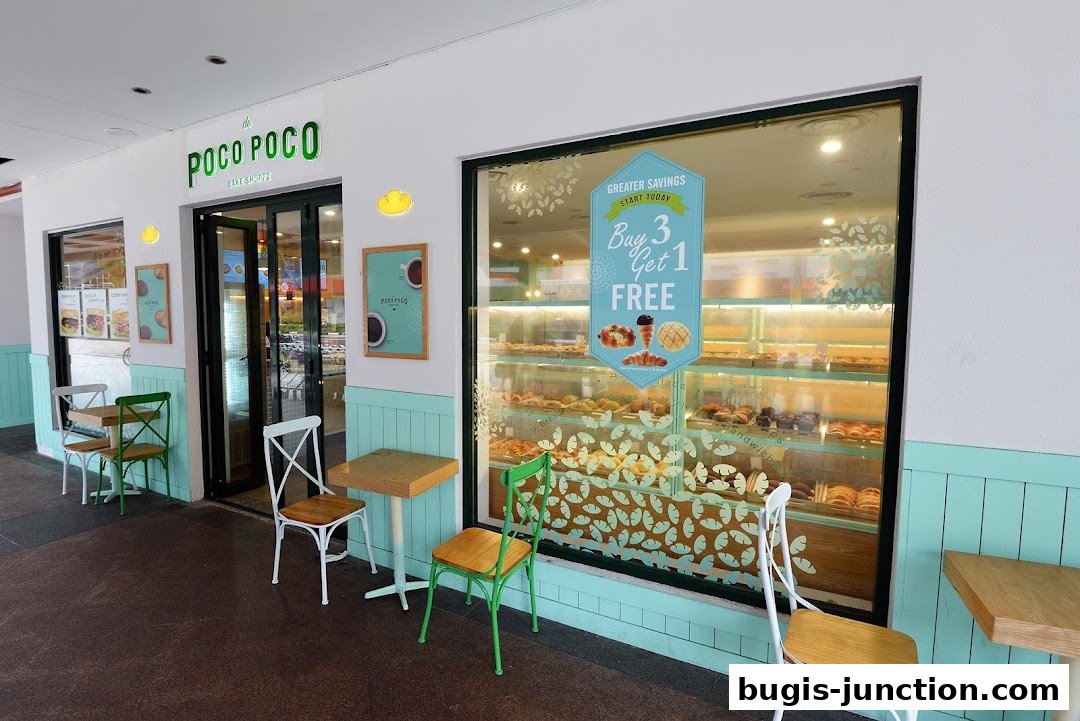The exterior of Poco Poco Bake Shoppe, featuring a display window filled with baked goods and outdoor seating.