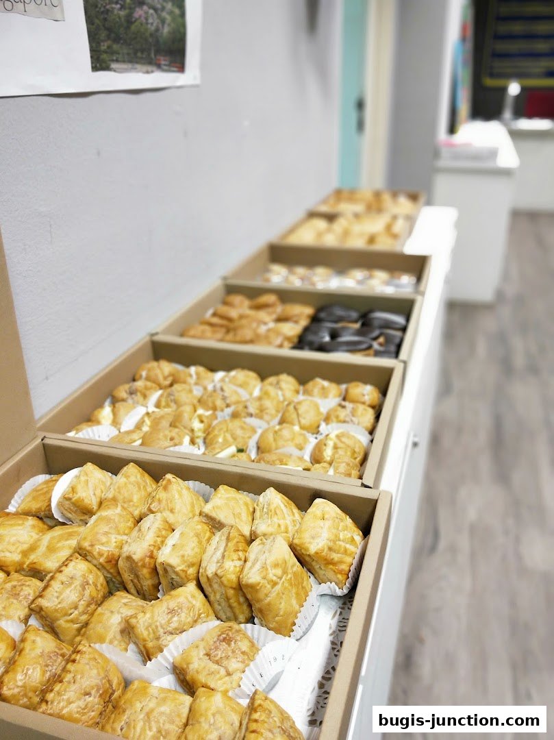A display of assorted pastries and baked goods in cardboard boxes.