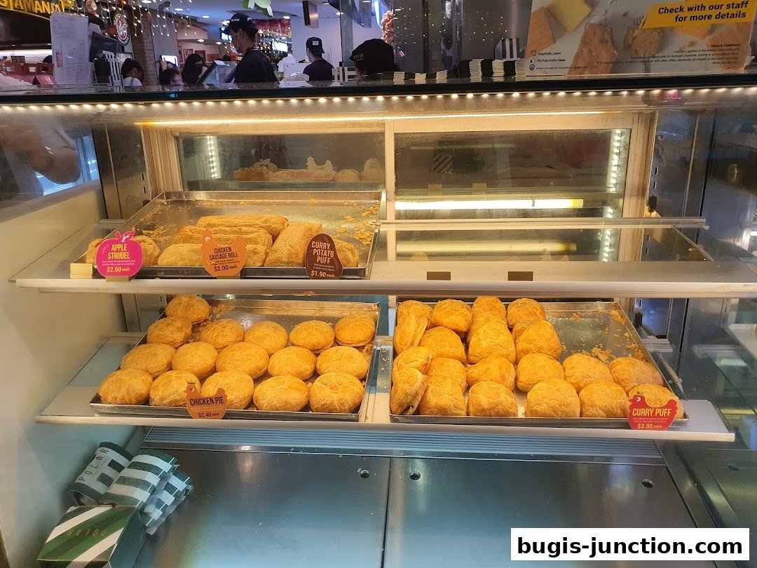 A display case filled with various pastries and baked goods from Polar Puffs Cakes.