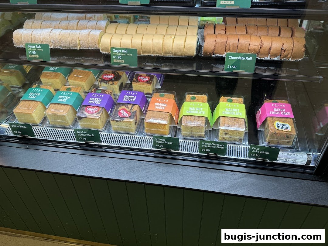 A display case filled with various cakes and rolls from Polar Puffs & Cakes.