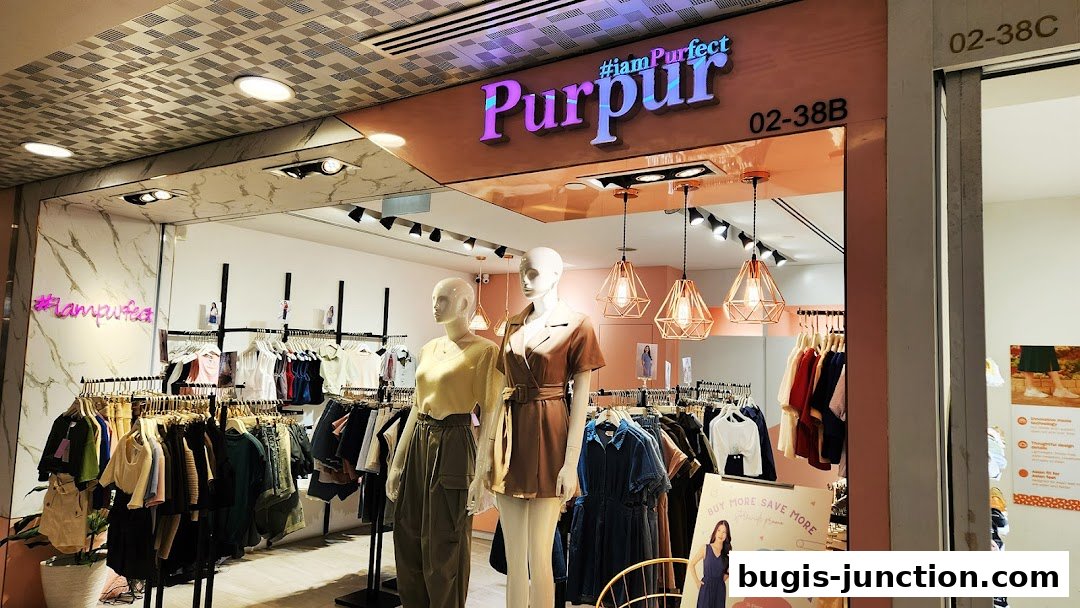 A fashion boutique with mannequins and racks of stylish clothing displayed.