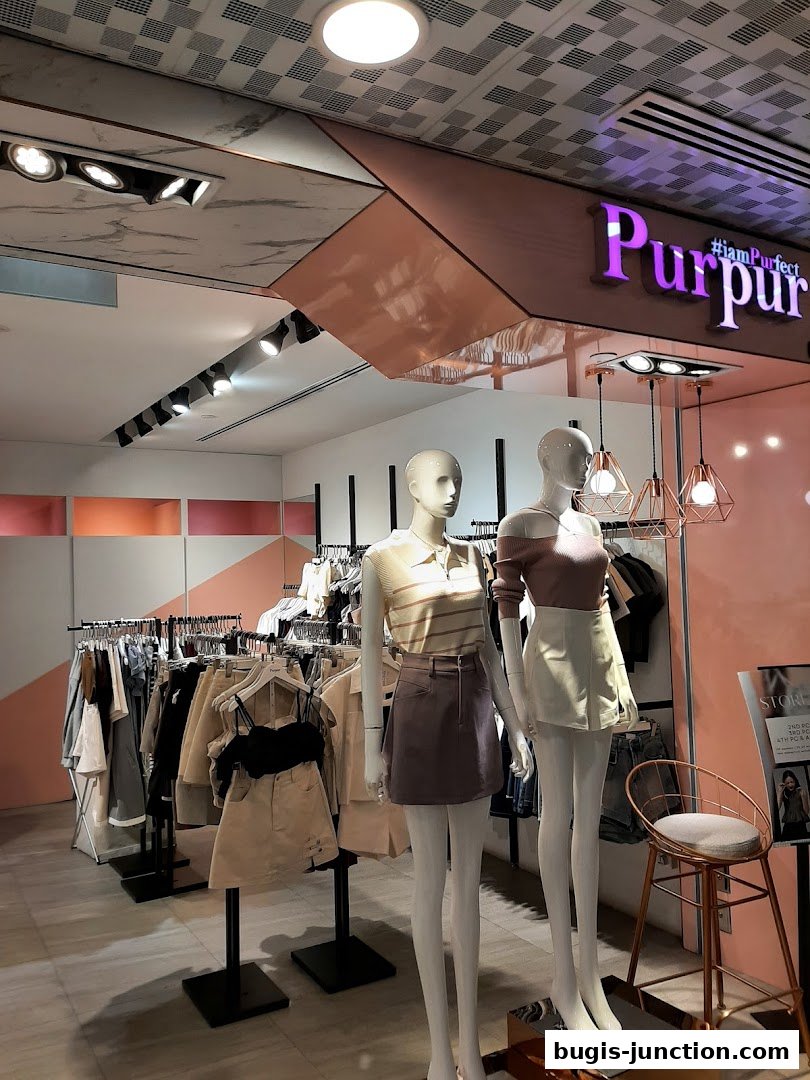 Mannequins display stylish outfits in front of racks of clothing at Purpur.