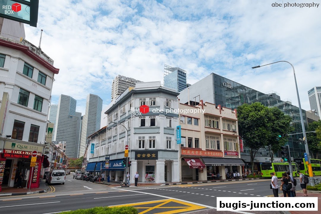 Street view of Q&M Dental Centre Bugis Junction and surrounding shops.
