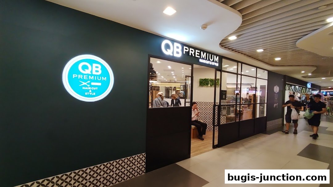 The exterior of QB PREMIUM Bugis Junction, a hair salon, with its logo and entrance visible.