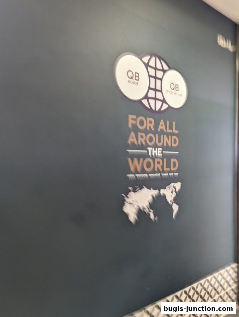 A wall with the QB Premium logo and a world map graphic.