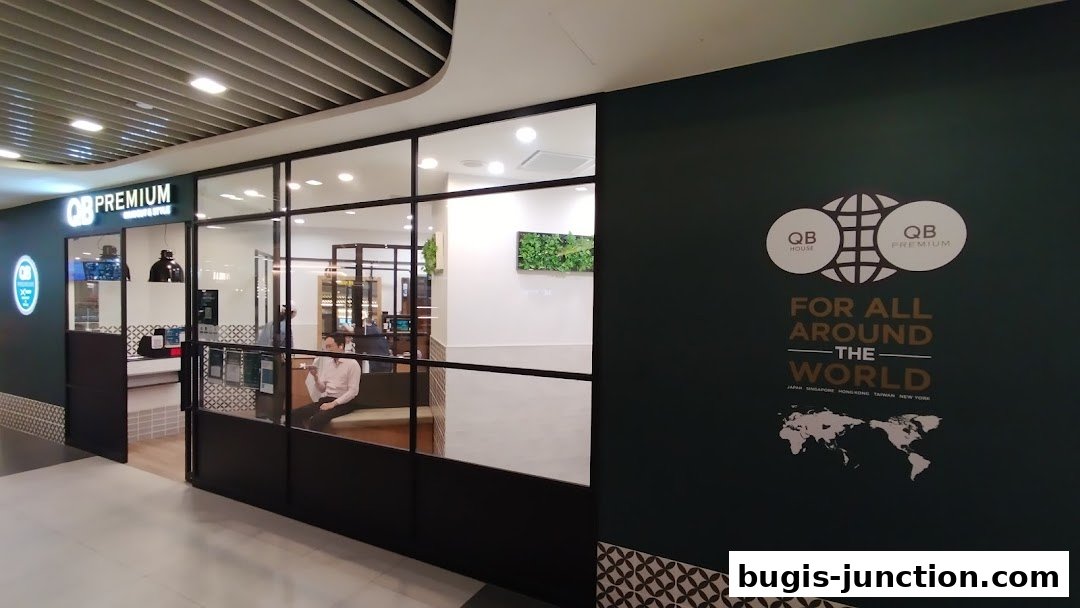 The exterior of QB PREMIUM Bugis Junction shop with a modern glass facade and branding.