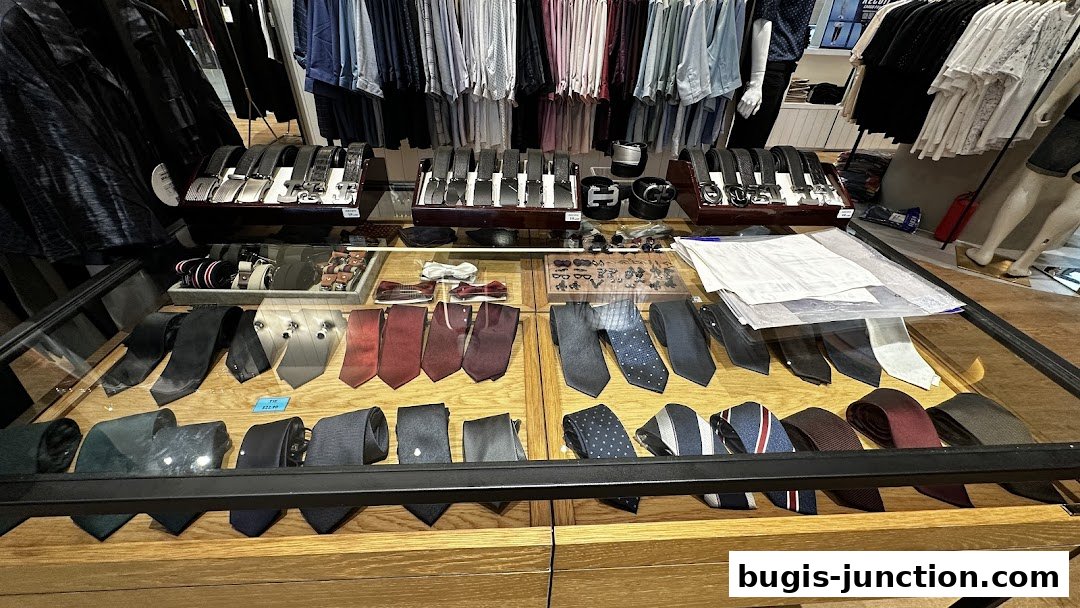 A display of men's ties and belts in a retail store.