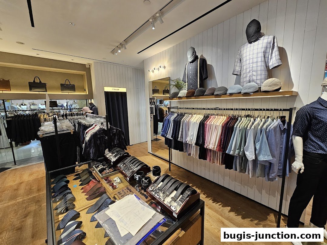 Interior view of a men's clothing store showcasing shirts, ties, hats, and accessories.