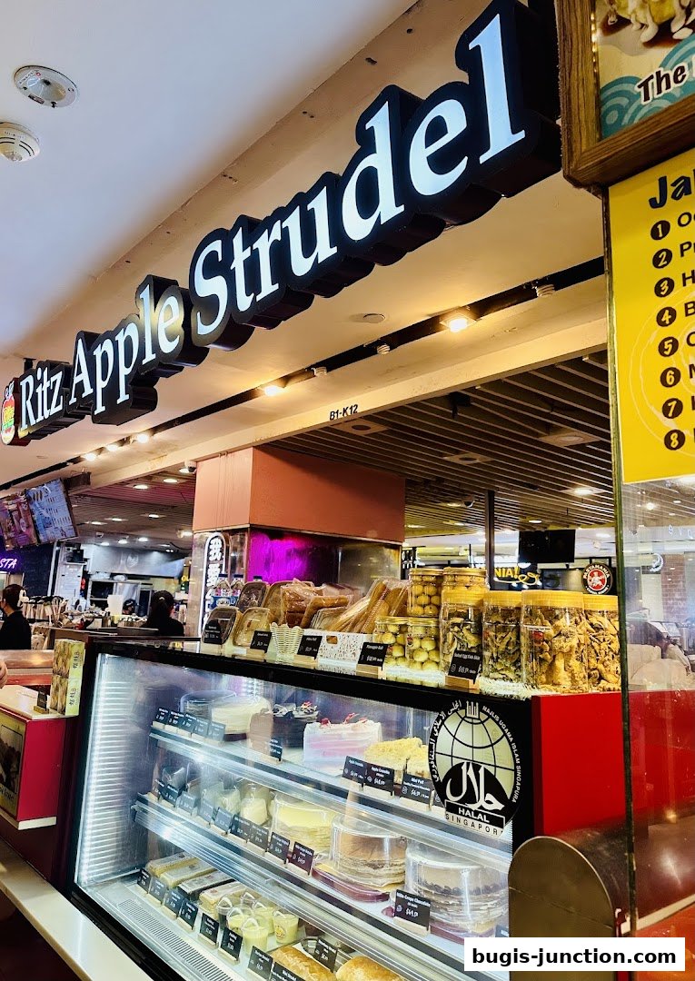 A display case filled with cakes and pastries at Ritz Apple Strudel.
