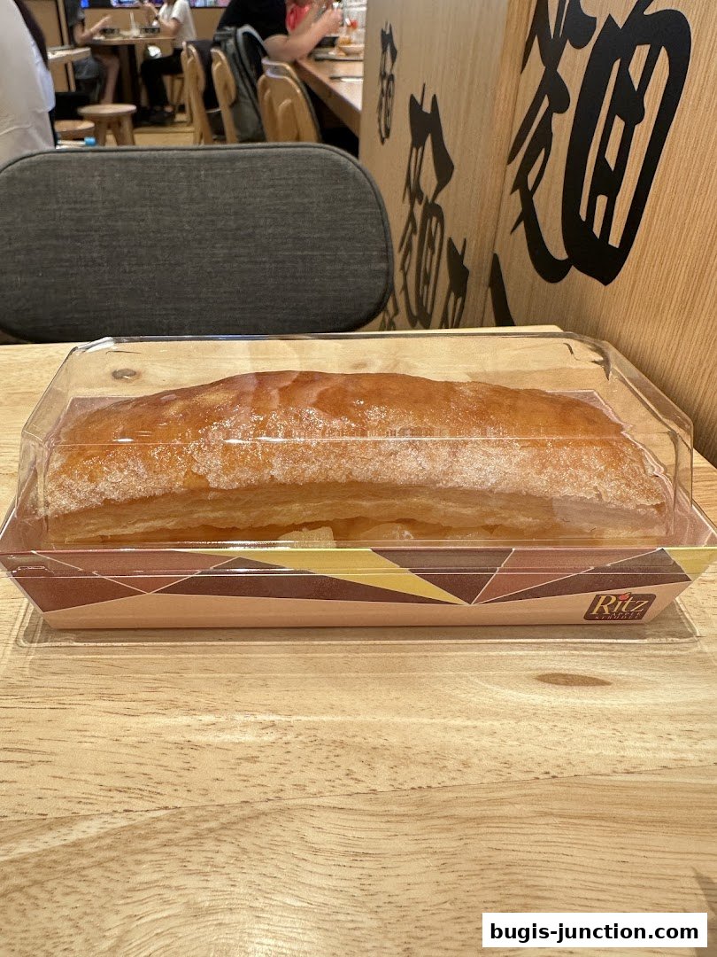 A packaged Ritz Apple Strudel on a wooden table with blurred background.