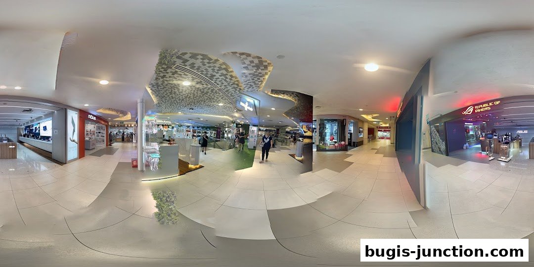 Interior view of a shopping mall corridor with several retail stores, including ROG.