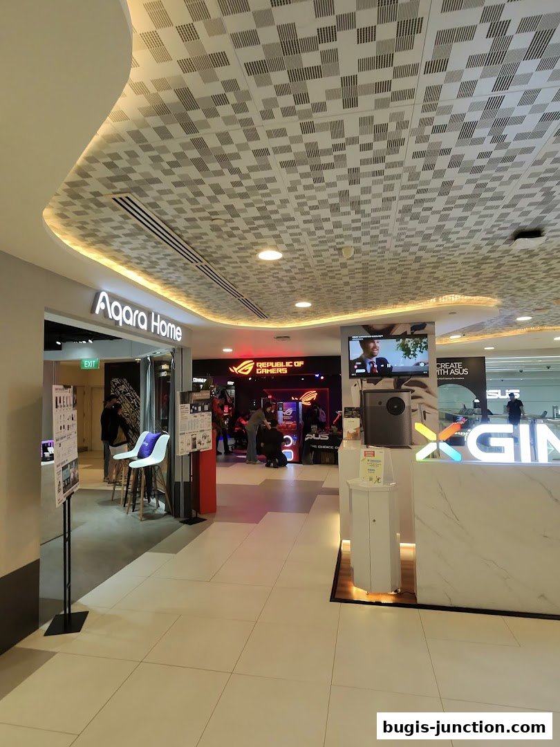 Interior view of a shopping mall corridor with the ROG Experience Store and Aqara Home visible.