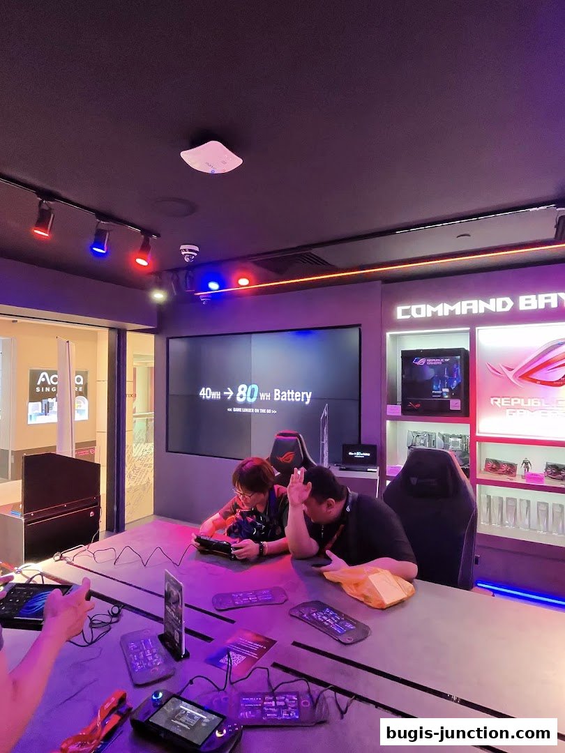 People testing gaming devices at a table in a ROG Experience Store.