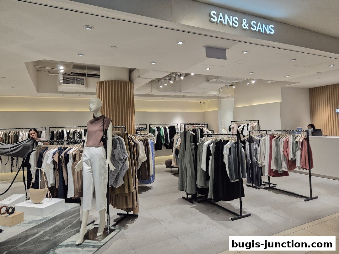 Interior view of a clothing store with mannequins and racks of apparel.