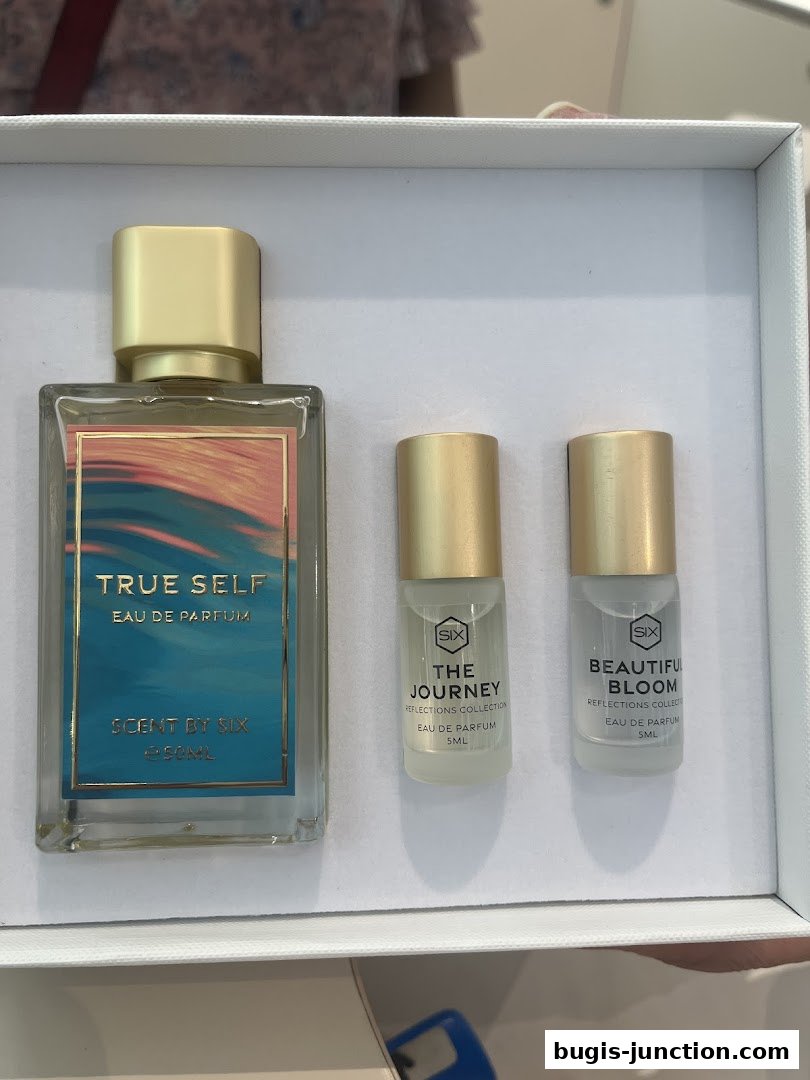 A gift set featuring a large bottle of 'True Self' perfume and two smaller rollerball perfumes.