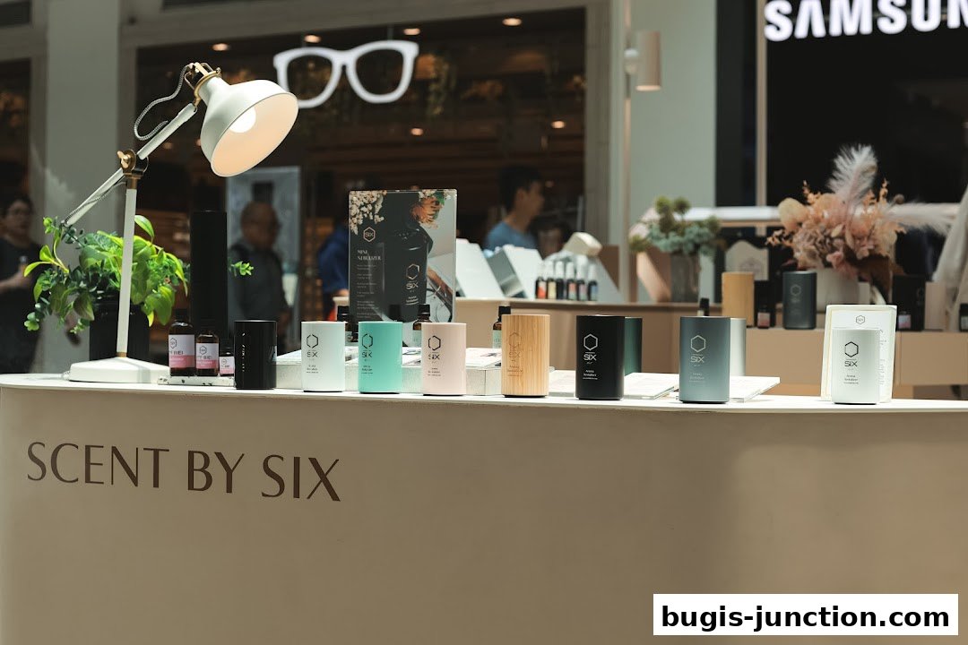 A display of Scent by SIX products, including diffusers and bottles, on a counter.