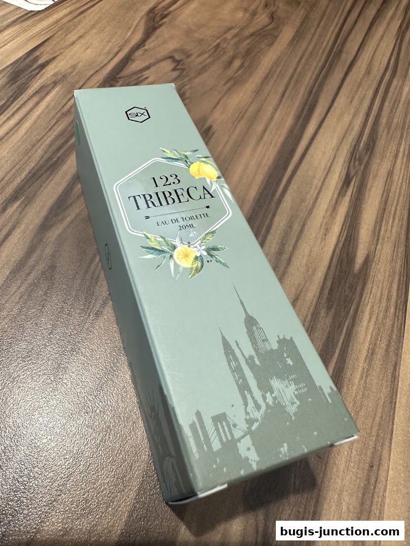 A light green box for '123 Tribeca Eau de Toilette' with floral and city skyline graphics.