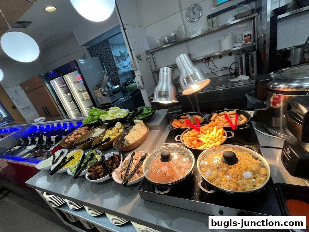 A buffet spread featuring various hot dishes, fresh vegetables, and fried items.