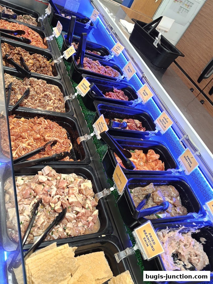 A display of various marinated meats and seafood in a restaurant setting.