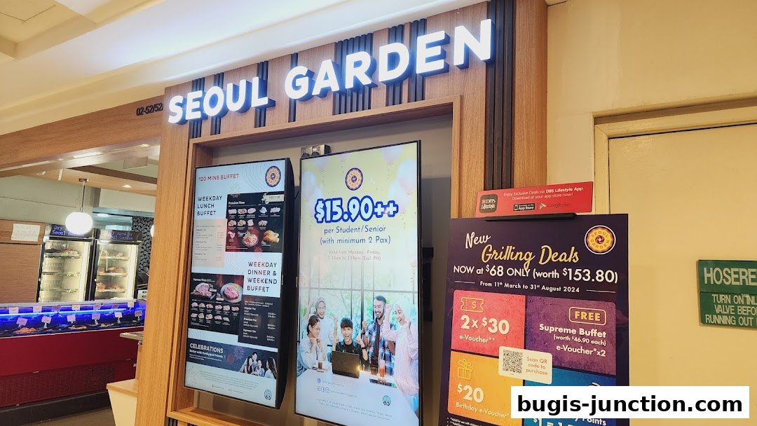 The entrance of Seoul Garden restaurant with illuminated signage and digital displays showcasing promotions.