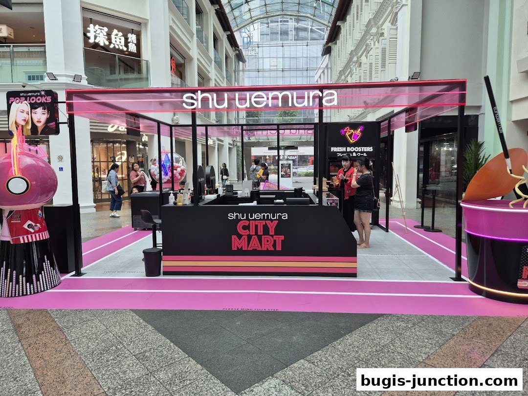 Shu Uemura City Mart pop-up store with staff and promotional displays.