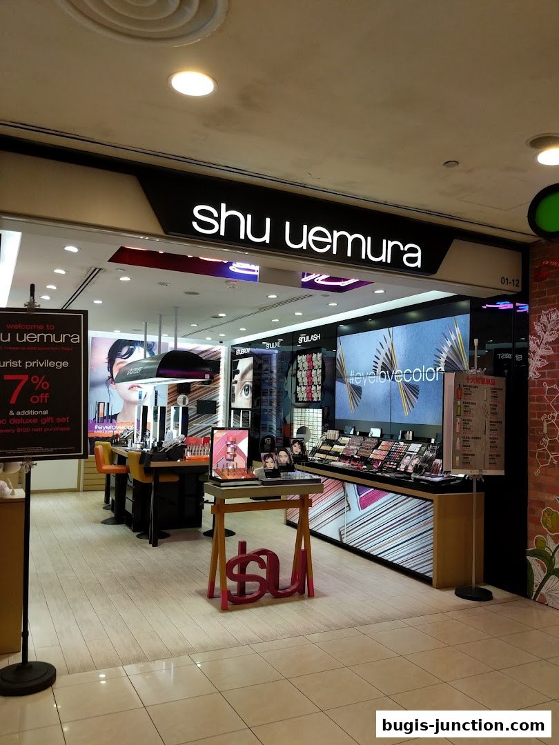 The Shu Uemura shop front displays makeup products and promotional signage.