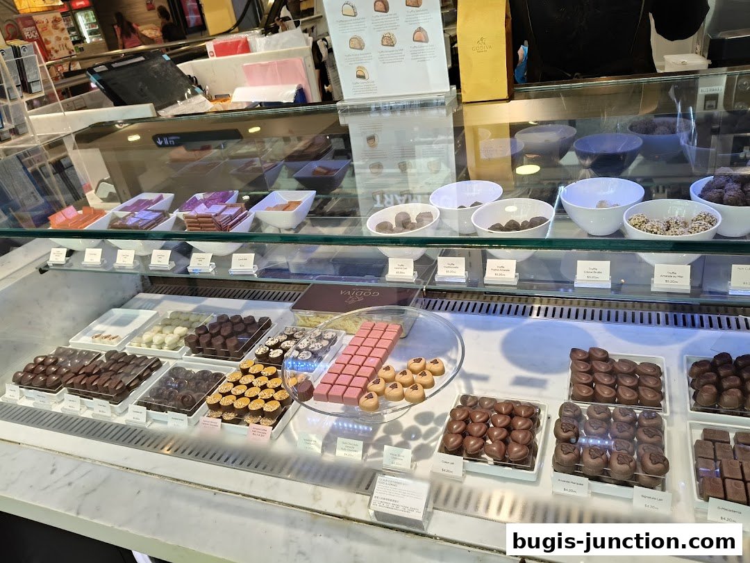 A display case filled with various Godiva chocolates, including truffles and chocolate bars.