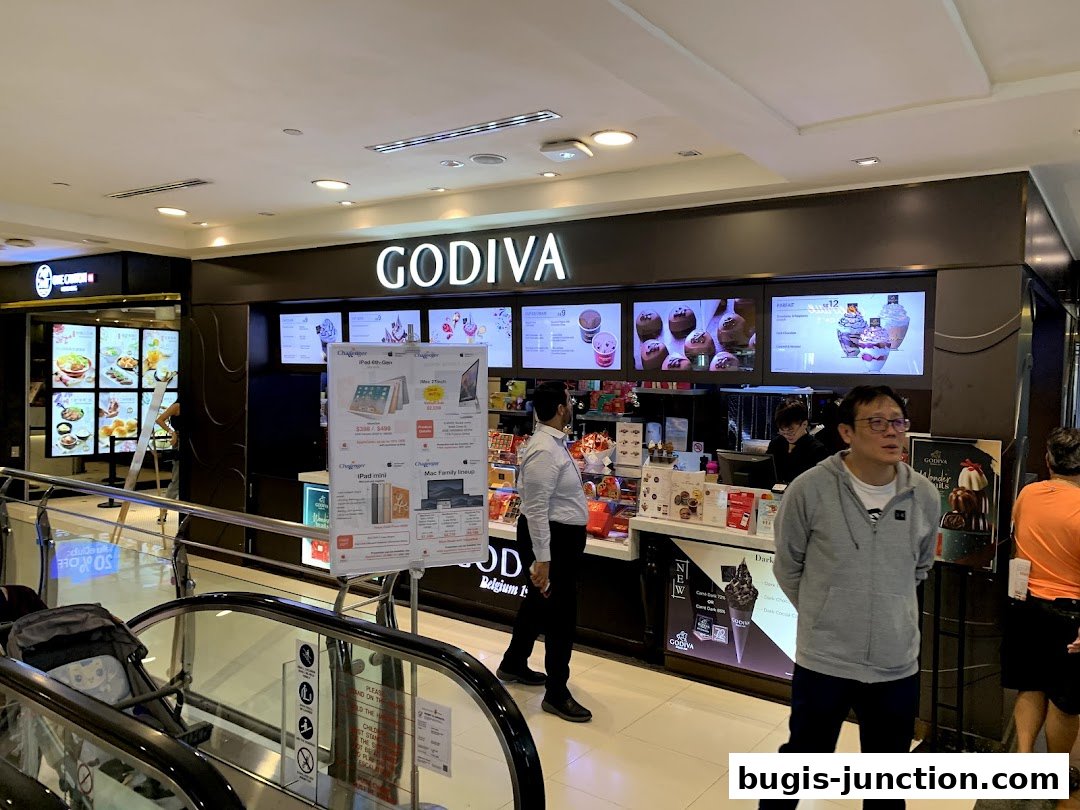 The Godiva chocolate shop entrance with displays of chocolates and ice cream.
