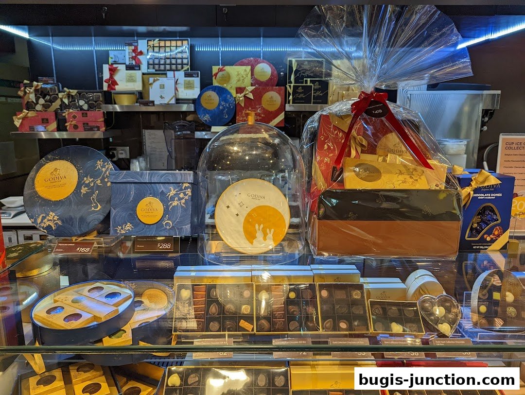 A display of Godiva chocolates, including gift boxes, domes, and assorted chocolates.