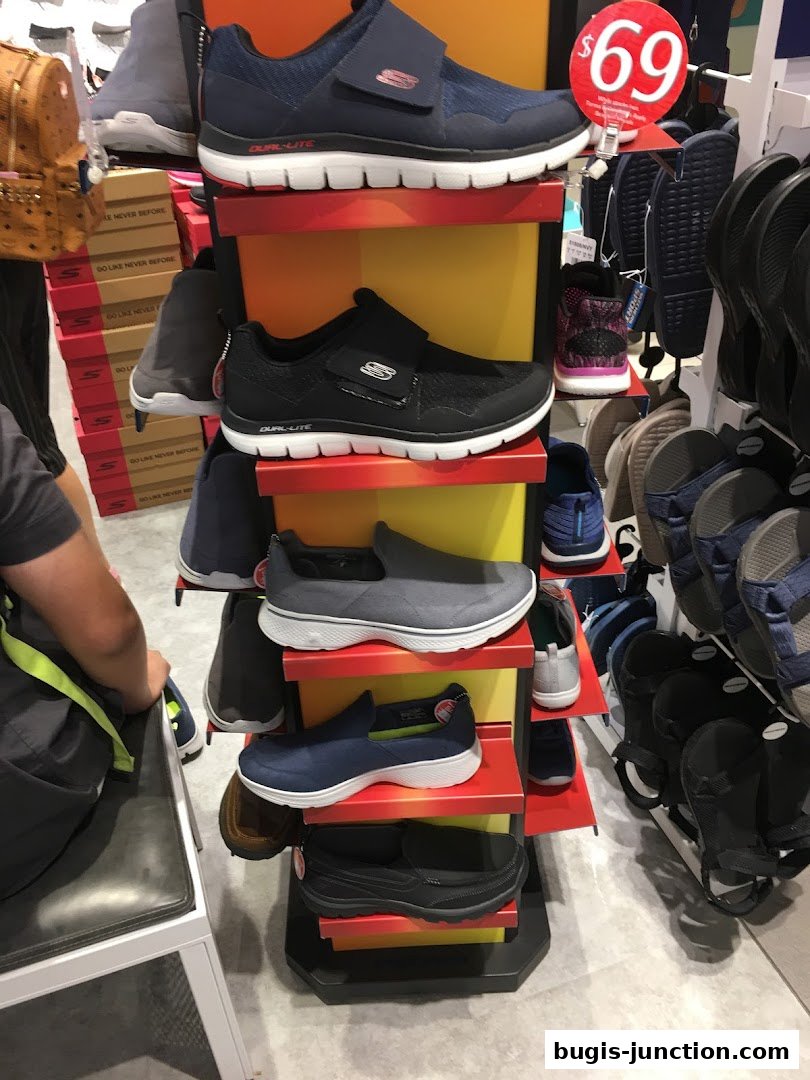 A display of Skechers shoes, including sneakers and slip-ons, with a price tag of $69.