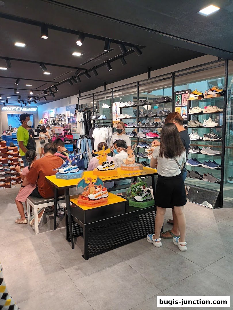 Customers browse Skechers shoes, including a special display featuring Pokémon-themed sneakers.