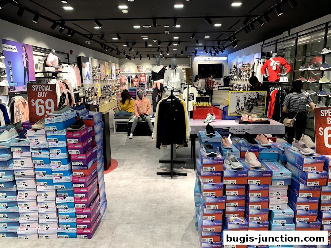 Interior view of a Skechers store showcasing shoes and apparel with a special buy display.