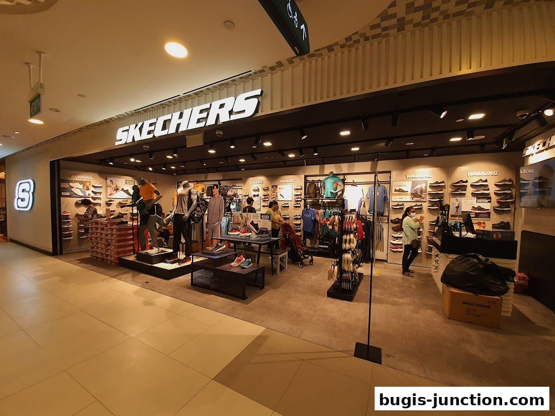 The Skechers Bugis Junction store displays a wide variety of shoes and apparel with mannequins showcasing outfits.