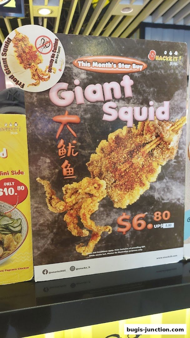 A promotional poster for Snackz It! featuring a giant fried squid.