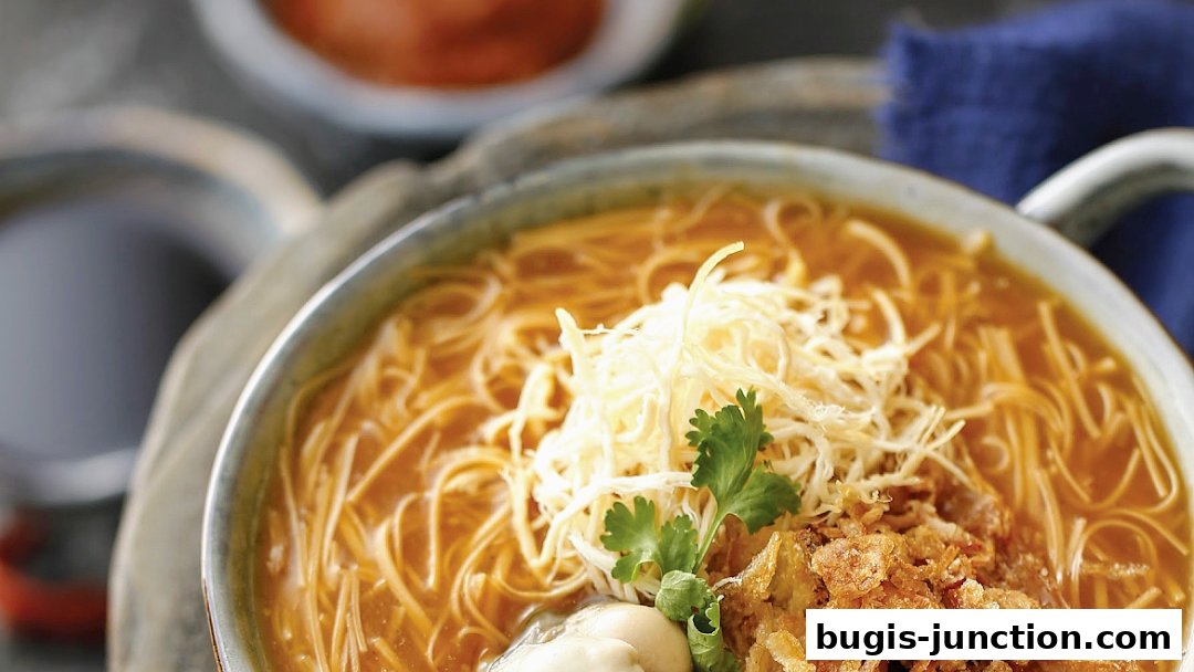 A close-up shot of a steaming bowl of noodle soup with shredded toppings and a sprig of cilantro.