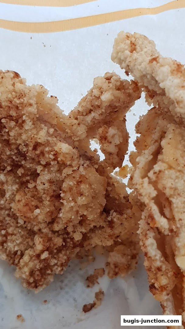 Close-up of crispy, golden-brown fried chicken pieces with a textured coating.