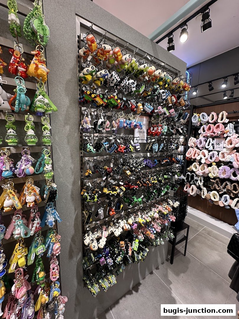 A shop interior displaying a wide variety of colorful keychains and accessories on display racks.