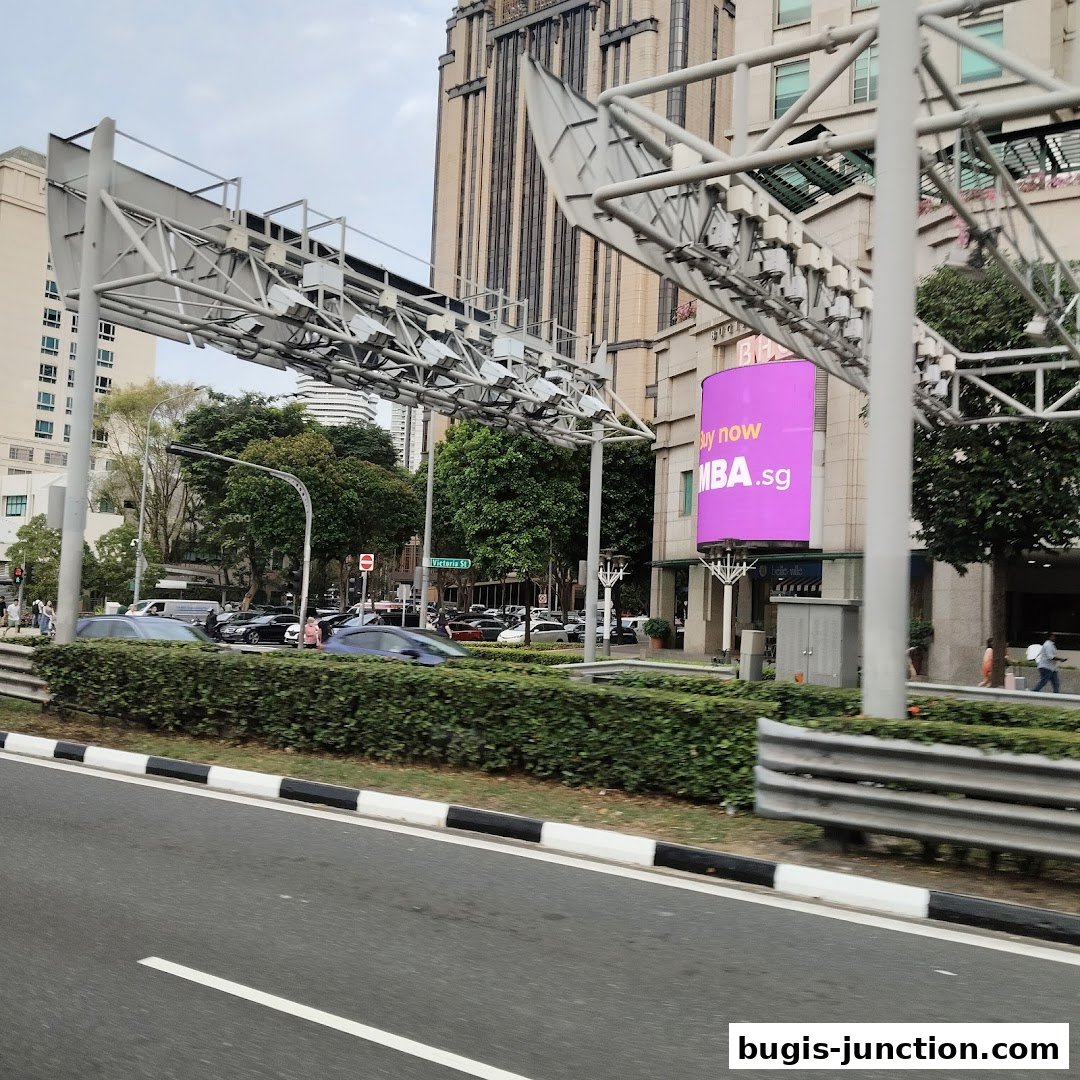 A street view with a large pink billboard advertising MBA.sg.