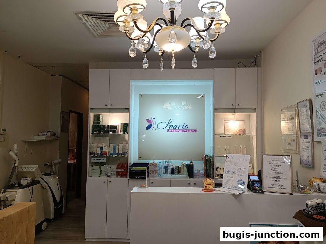 Interior of a beauty salon with a reception desk, product displays, and treatment equipment.