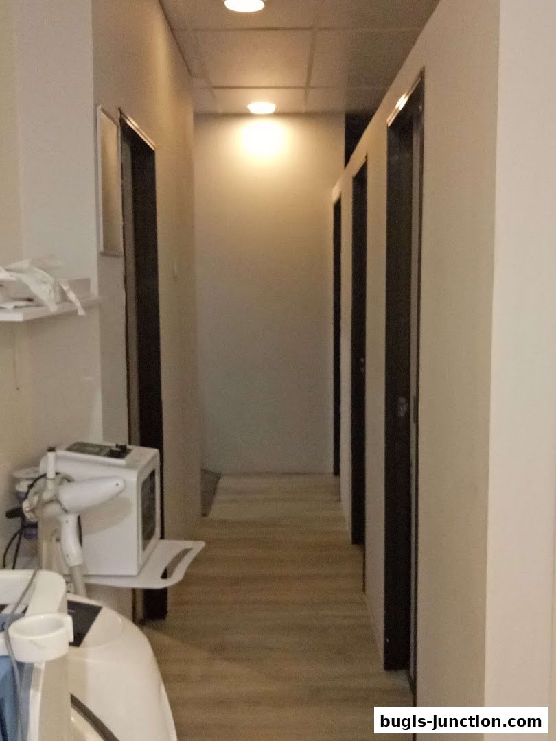 Interior hallway with multiple doors and medical equipment.